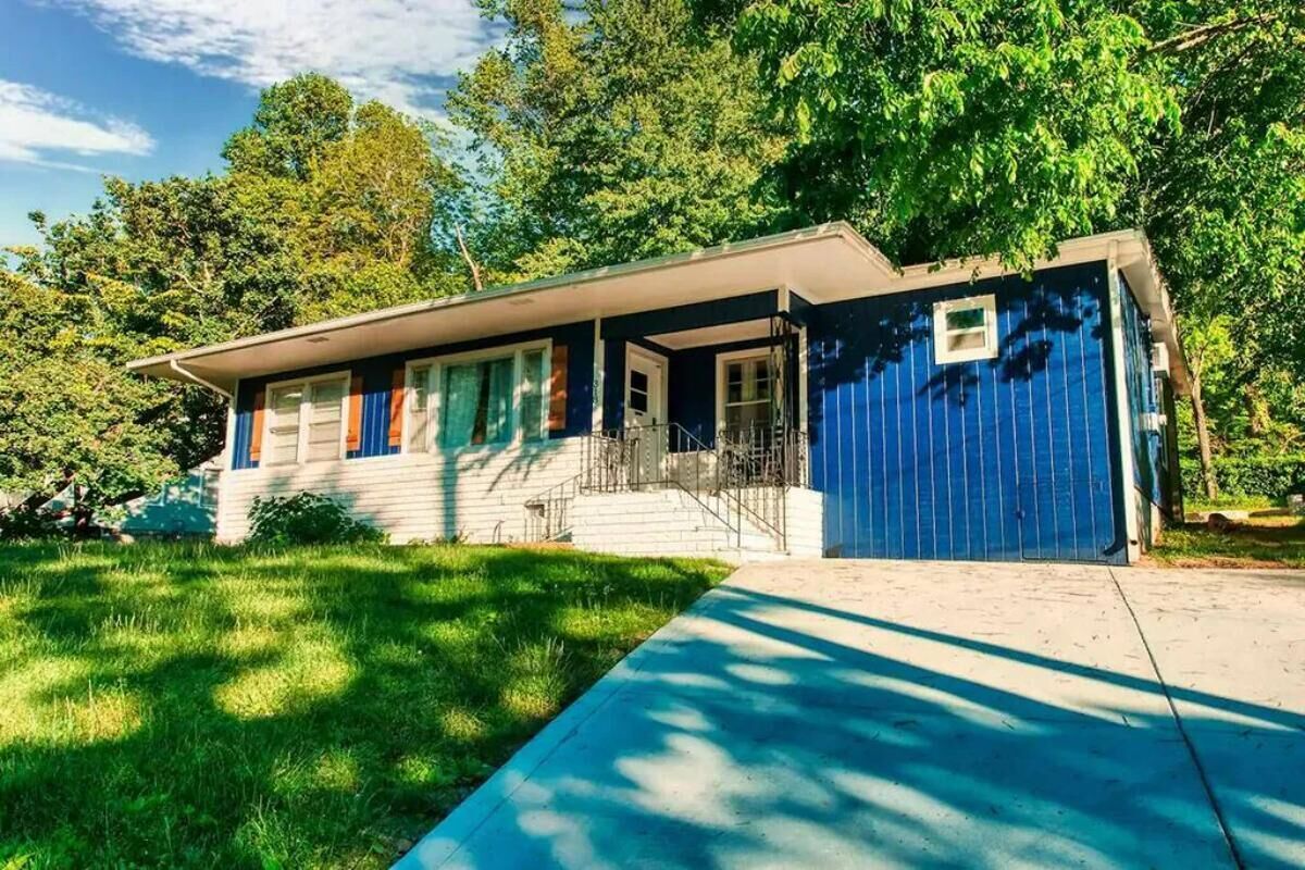 A single-story house with a front porch, a garage, and a well-maintained lawn.