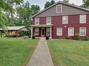 A two-story building with a covered patio area and a front door. - A Family Tradition (Gatlinburg)