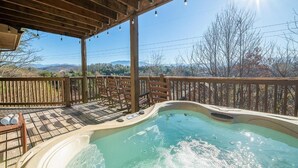 A hot tub under a wooden pergola with a view of mountains and trees. - Birdies and Bearcubs (Pigeon Forge)