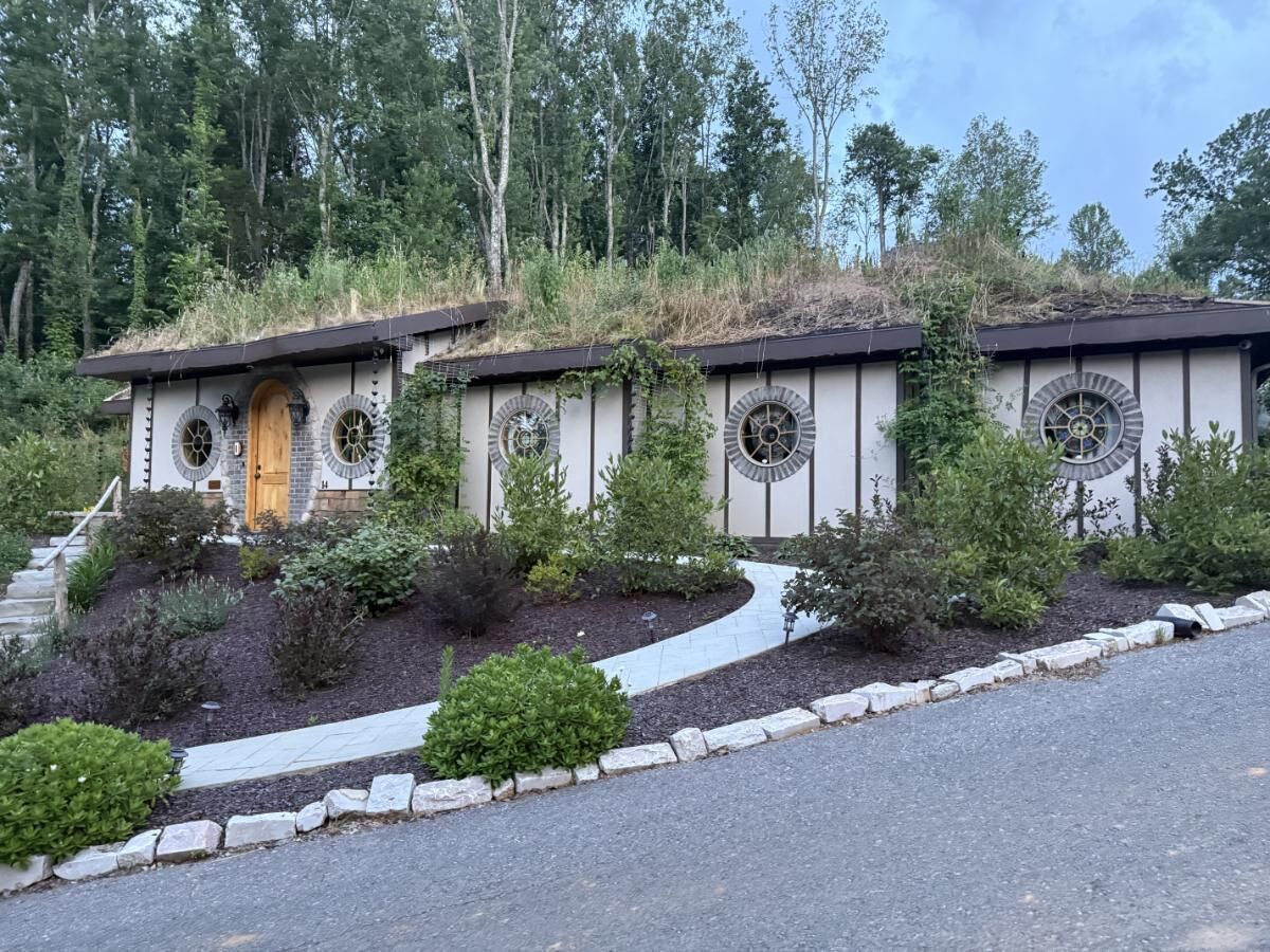A building with a unique architectural design featuring circular windows and a sloped roof.