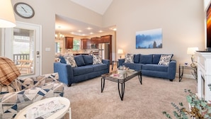A living room with two sofas, a coffee table, and a fireplace. - Fabulous Farmhouse (Sevierville)