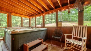A wooden cabin with a hot tub, a rocking chair, and a fan. - Z - Lone Wolf (Sevierville)