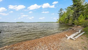 A lake with a pebble beach, trees, and a clear sky. - NEW LISTING SPECIAL! Rangeley Lake | Shared Dock | Pet Friendly (Rangeley)