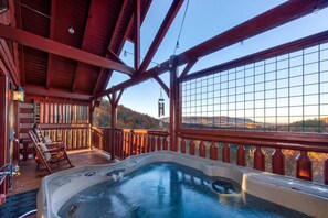 A hot tub on a wooden deck with a view of the mountains. - Z - Tennessee Whiskey (Sevierville)