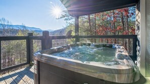 A hot tub on a wooden deck with a view of trees and mountains. - Eagles Nest Hideaway (Cosby)