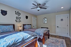A bedroom with two beds, a ceiling fan, and decorative wall art. - Private Pond, Mountain Escape (Highlands)