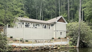 A cabin with a stone foundation, a balcony, and a pond in front. - Private Pond, Mountain Escape (Highlands)