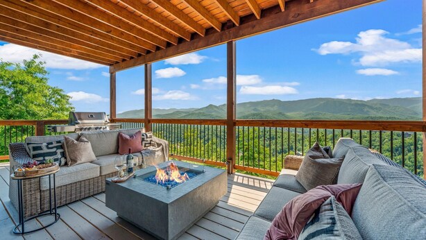 A deck with a fire pit, outdoor furniture, and a grill. - Premier Mountain Views (Gatlinburg)