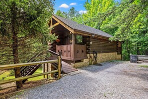A log cabin with a porch, a staircase, and a gravel driveway. - Mountain Dream (Sevierville)