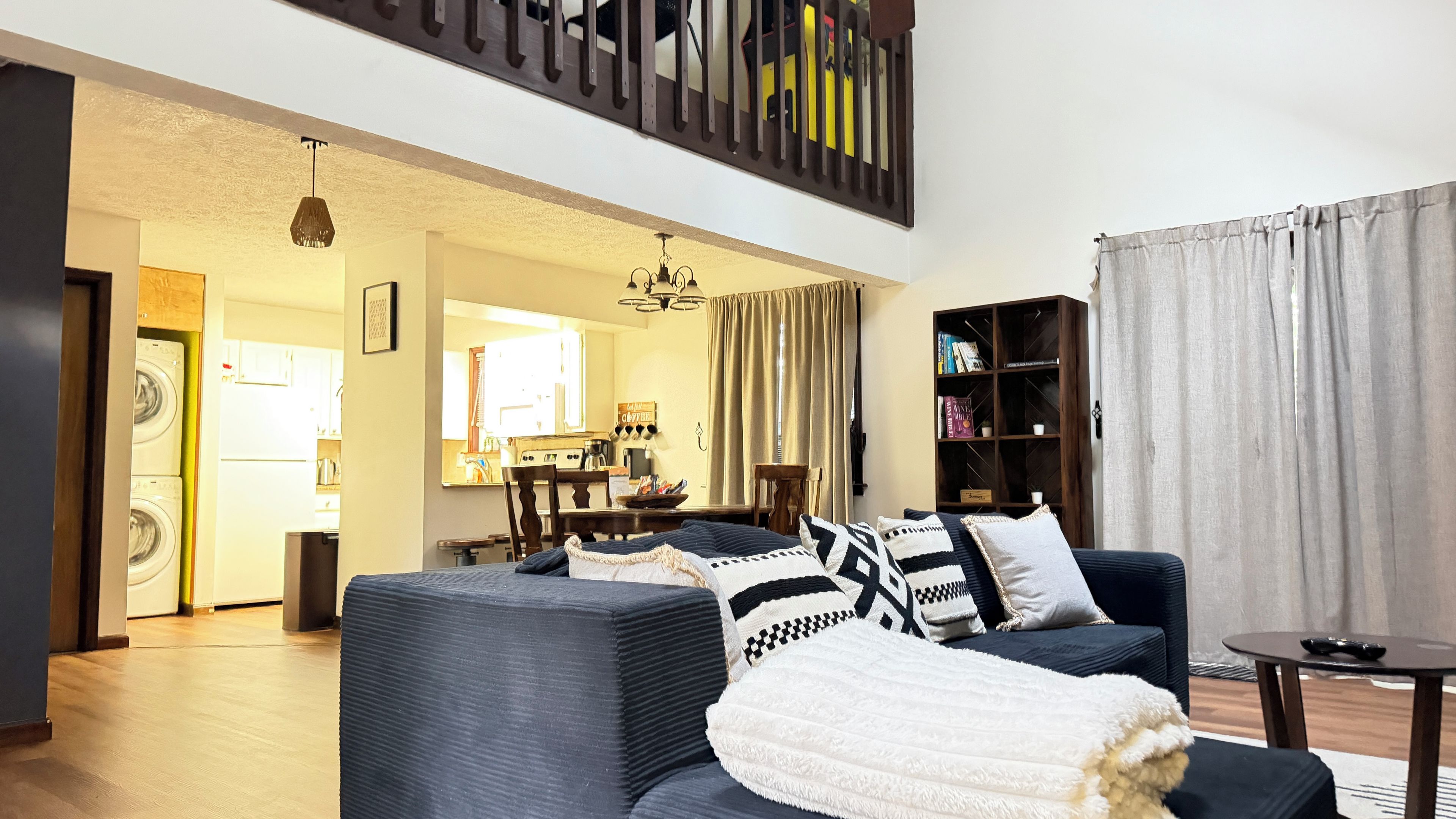 A living room with a sofa, a coffee table, and a bookshelf.