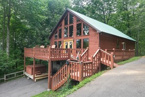 A wooden cabin with a balcony, stairs, and a covered porch area. - Simply Incredible (Sevierville)