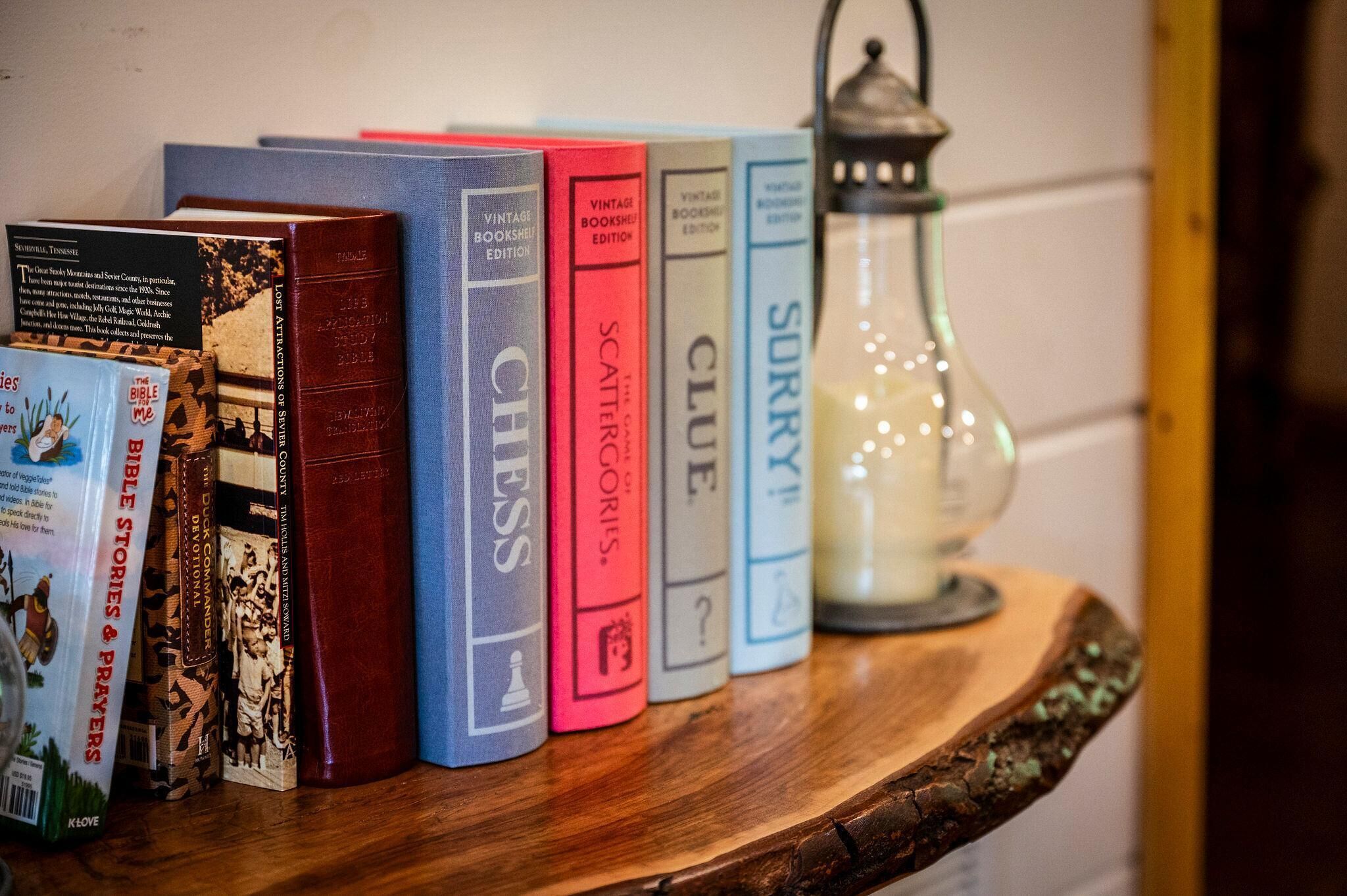 A bookshelf with various books and a vintage lantern.