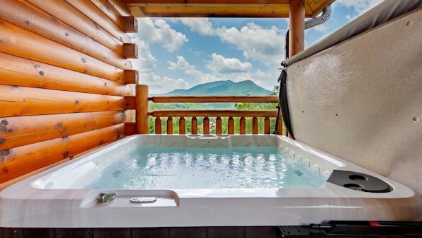A hot tub in a wooden cabin with a view of mountains. - Smokey Waters (Sevierville)