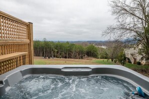 A hot tub with a view of a forest and mountains in the background. - Kodak Moments (Kodak)