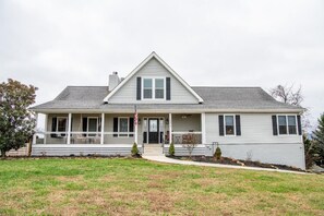 A two-story house with a front porch, a flag, and a small front yard. - Kodak Moments (Kodak)