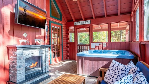 A cabin with a stone fireplace, a hot tub, and a sign that reads 'Bless Our Home.' - Lasting Memories (Sevierville)