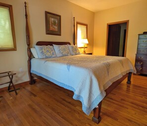 A bedroom with a four-poster bed, a dresser, and a nightstand with a lamp. - Llyn Blaen House at Lake Junaluska (Lake Junaluska)