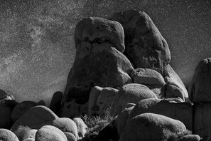 A rocky landscape with large boulders and sparse vegetation. - Ultimate Retreat|Pool~Spa~Pickleball~GameRoom~BBQ (Twentynine Palms)