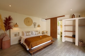 A modern bedroom with a large bed, a wooden bench, a wall-mounted shelf, and a large window. - Villa Surya Tanah by Alfred in Bali (Seminyak)