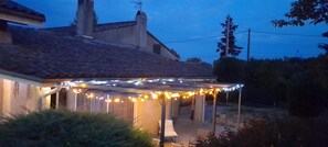 A house with a covered patio area, string lights, and a chimney. - La Grangère Vineyard - MONTAUT (MONTAUT)