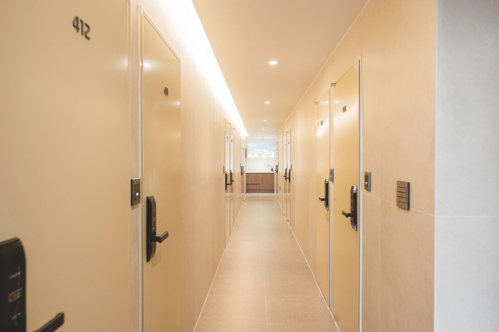A hotel hallway with doors numbered 412, leading to rooms.