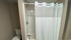 A bathroom with a toilet, a shower, and a bathtub. - Close to the Causeway! (Naples)