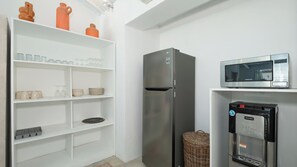 A modern kitchen with a stainless steel refrigerator, a microwave, and a water dispenser. - Villa Mas Estate (Kuta)