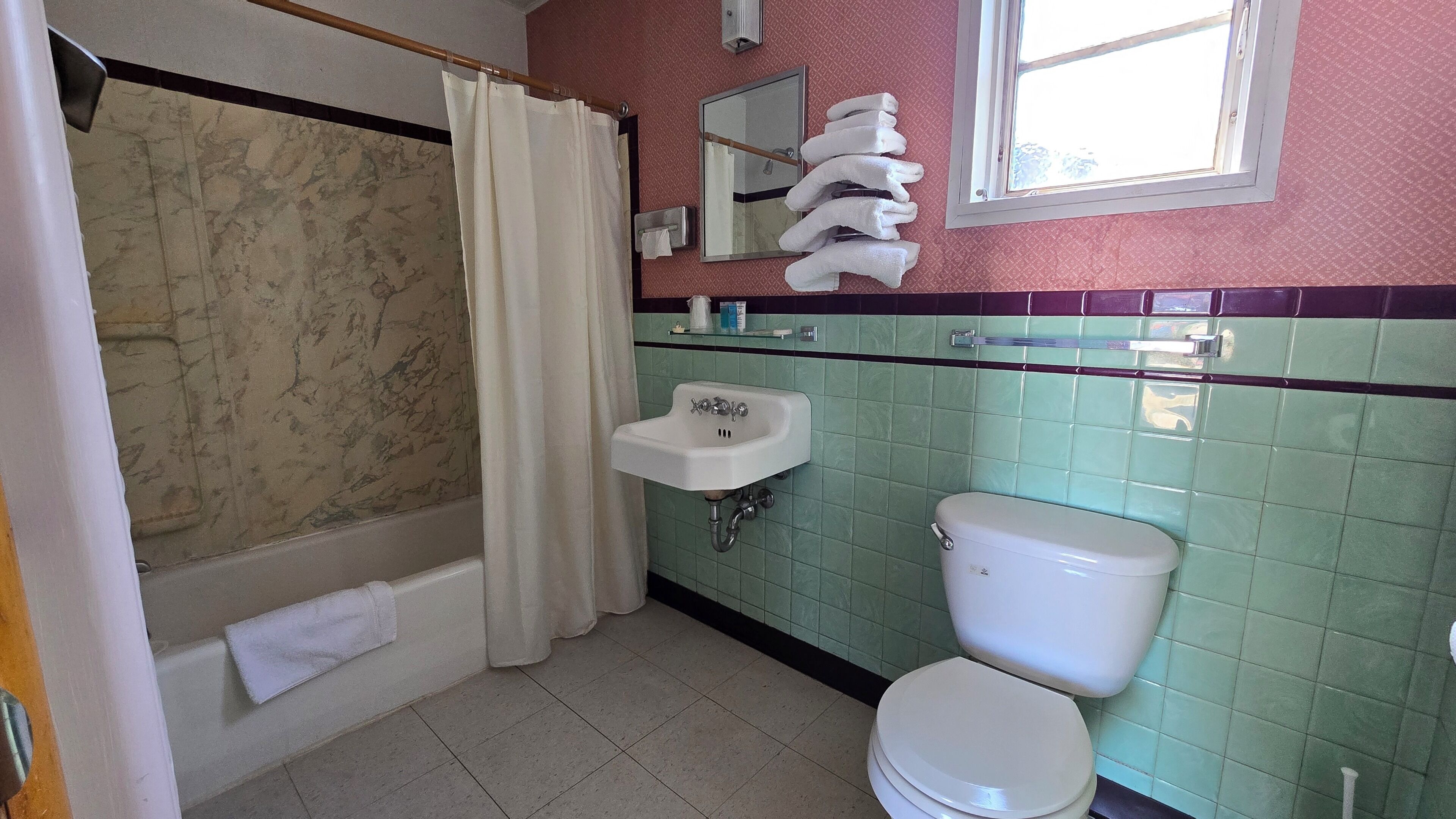 Bathtub, towels, soap, shampoo