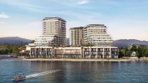 A waterfront hotel with multiple high-rise buildings, a boardwalk, and a view of the water. - Luxury Living at Aqua | Pool, Spa, Golf Sim plus Downtown Kelowna & Lake Views (Kelowna)