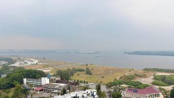 A coastal view with buildings, a road, and a body of water.