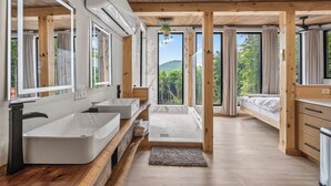 A modern bathroom with two sinks, a bathtub, and a shower. - Scandinavian-Modern Couples Retreat w/ Sauna, Hot Tub & Cold Plunge (Stow)