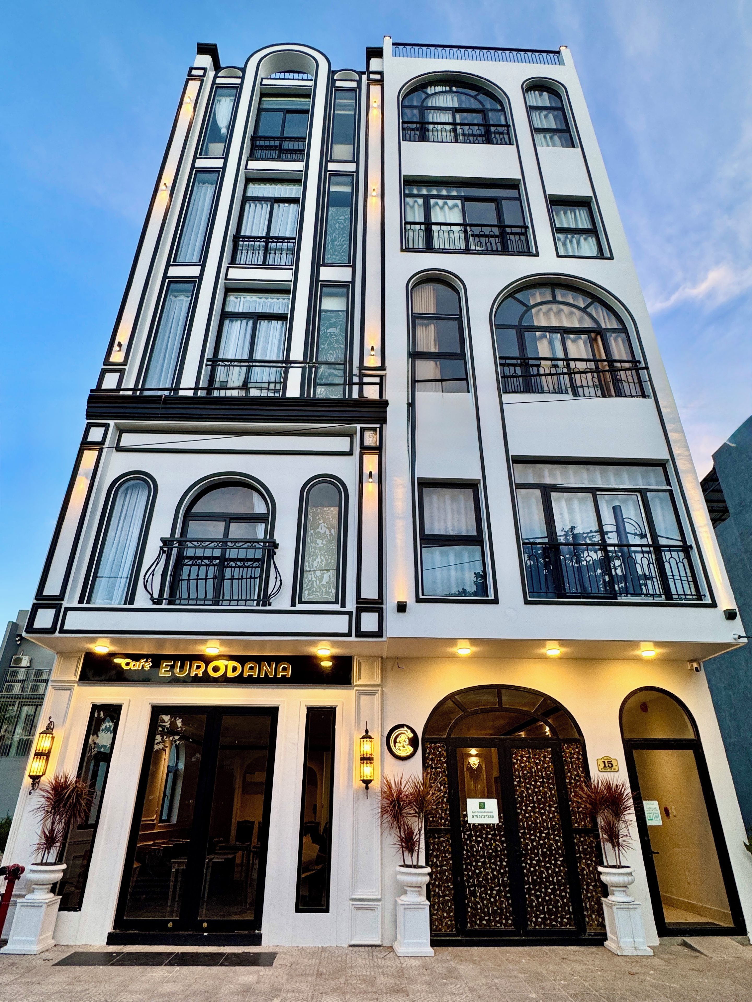 A multi-story building with a cafe named 'EUROANA' on the ground floor.