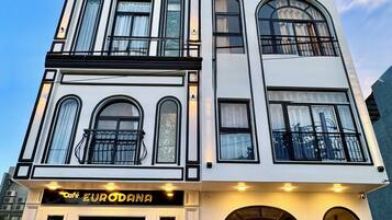 A multi-story building with a cafe named 'EUROANA' on the ground floor.