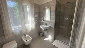 Standard Double Room | Bathroom | Shower, hair dryer, towels, soap