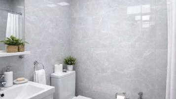 A modern bathroom with a toilet, sink, and shower.