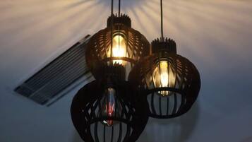 Three hanging pendant lights with a unique design.