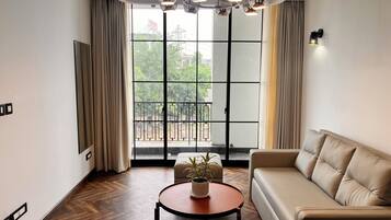 Family Suite, Balcony, City View | Living area | 32-inch LED TV with digital channels