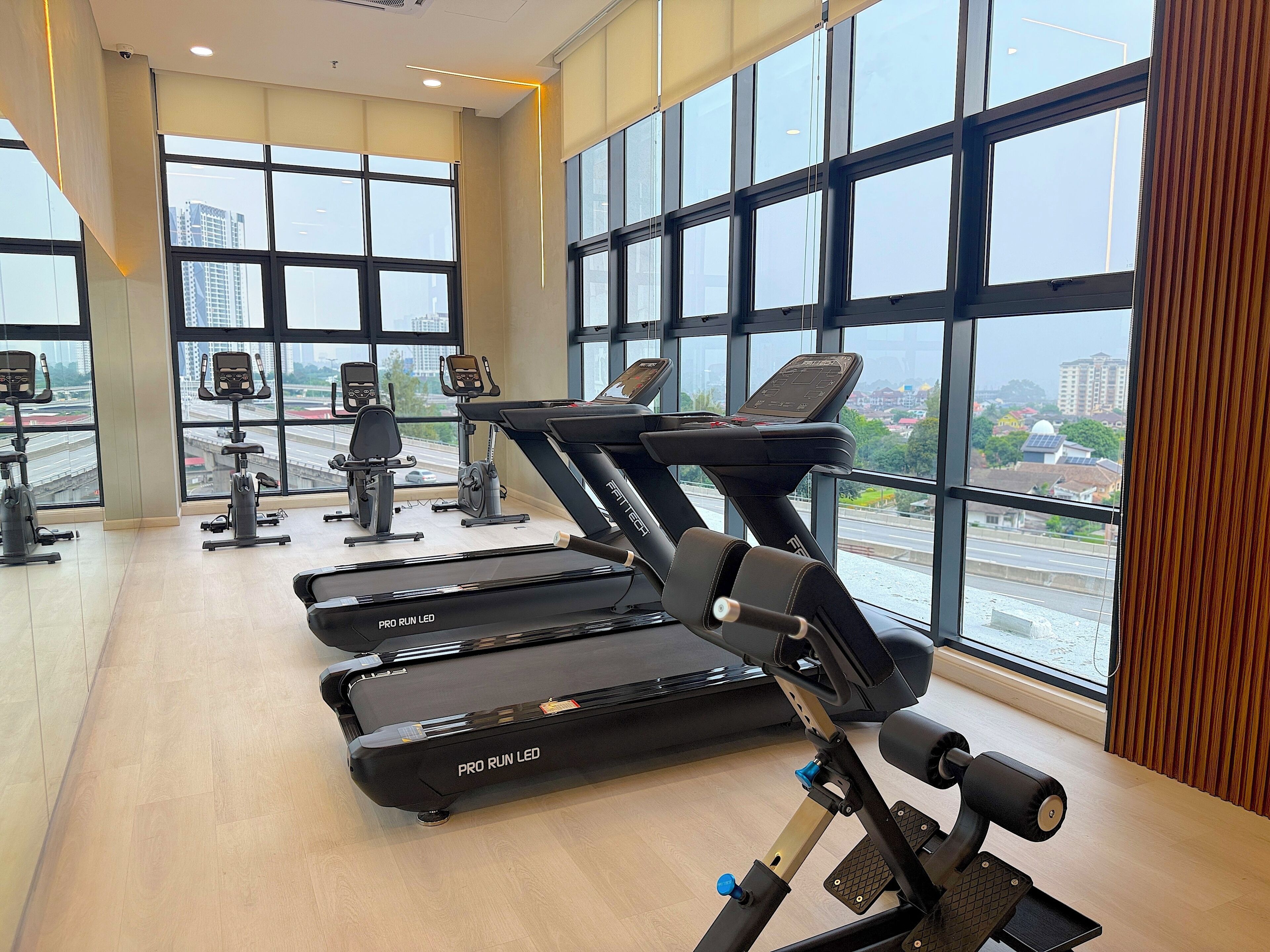 A gym with treadmills, stationary bikes, and exercise equipment.