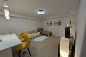 Living area - Modern 2-Bedroom 2-Bath Basement Suite in Aspen (Calgary)