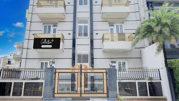 A multi-story building with balconies, a gated entrance, and a sign for 'Collection.' - Saver Single House of Dreams (Phagwara)