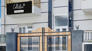 A gated entrance with a sign above reading 'Collection' and 'Company Serviced.' - Saver Single House of Dreams (Phagwara)