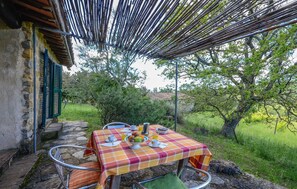 An outdoor dining area with a table set for breakfast, surrounded by stone steps and greenery. - Beautiful home in Saturnia (Saturnia)