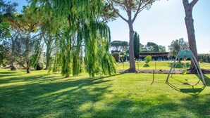 A park with a gazebo, trees, and a swing set. - Pet friendly apartment in Roccastrada with WiFi (Roccastrada)