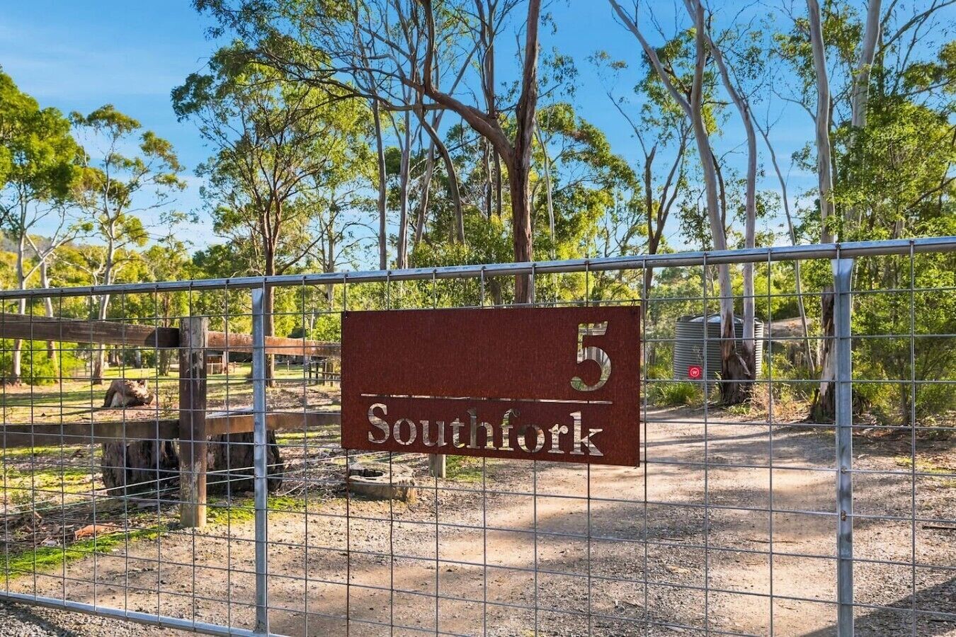 A fenced area with a sign reading '5 Southfork.'