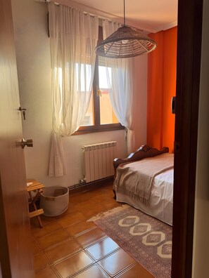 Tabla de planchar con plancha y ropa de cama 