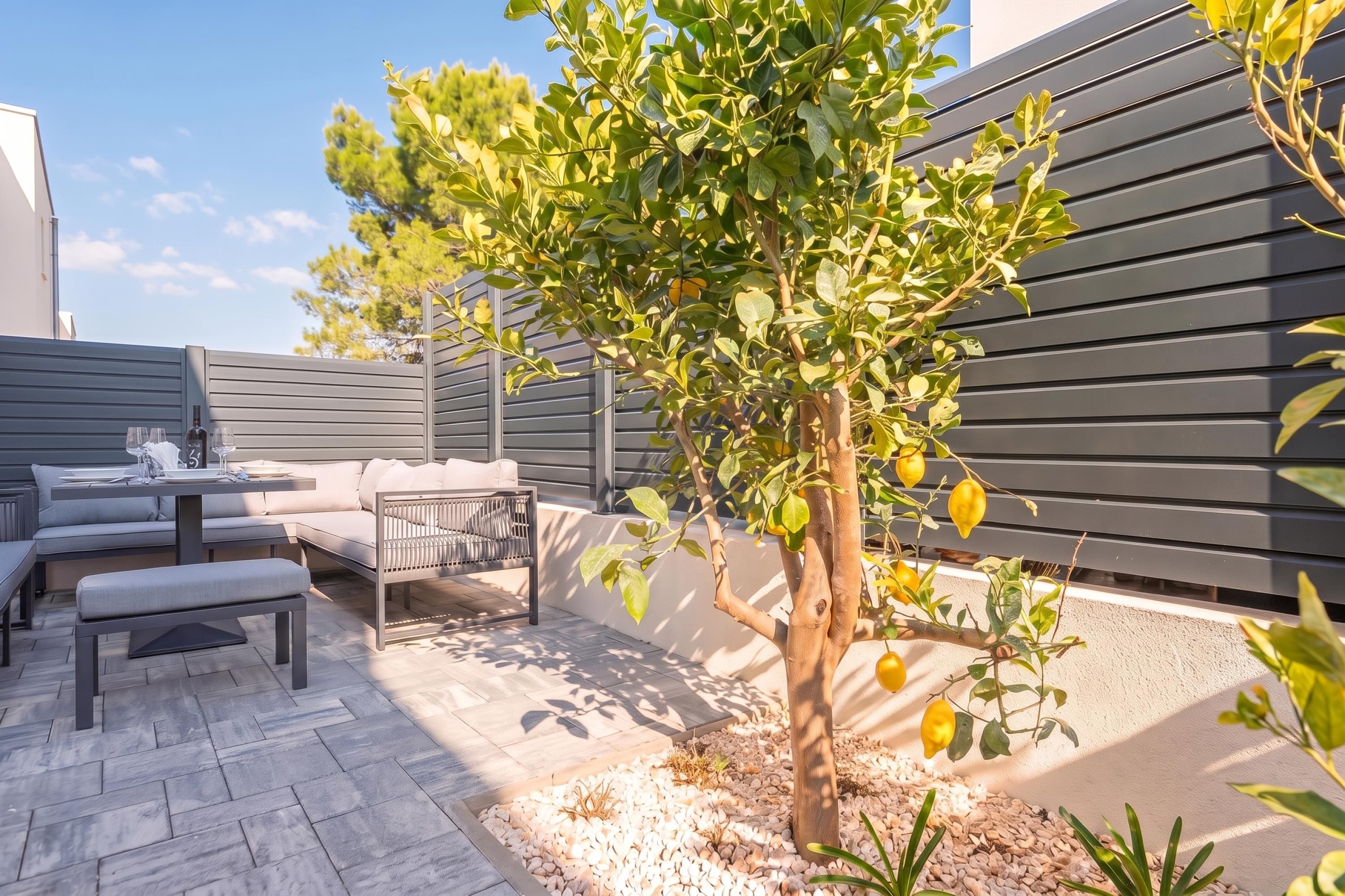 An outdoor patio area with a dining table, chairs, and a seating arrangement.