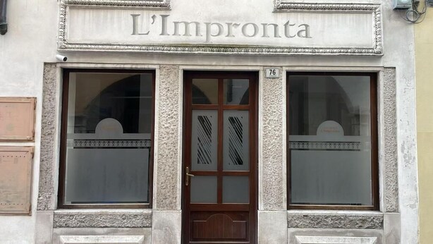 A building facade with a sign reading 'L'Impronta' and a number '76' above the entrance. - L'impronta (Gorizia)