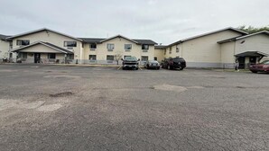 A multi-story parking garage with several vehicles parked.
