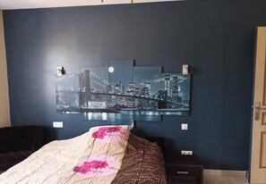 A bedroom with a bed, a nightstand, and a wall-mounted cityscape artwork. - 15-square-meter room, near the Airbus Helicopters facility in Marignane (Les Pennes-Mirabeau)
