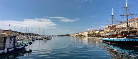 A harbor with boats, a dock, and buildings along the waterfront.